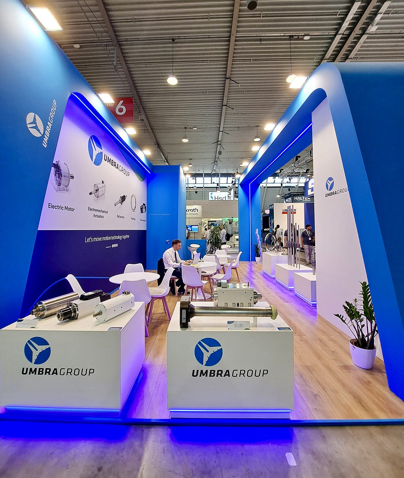 Side view of the stand with graphics and meeting tables
